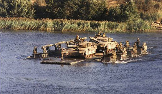 Ex ULAN EAGLE, Drawsko-Pomorskie training area, Poland: Two Chalenger 1 main battle tanks tanks crossing the Drawska river on a ferry made up of Royal Engineers M3 Amphibious Bridging Units